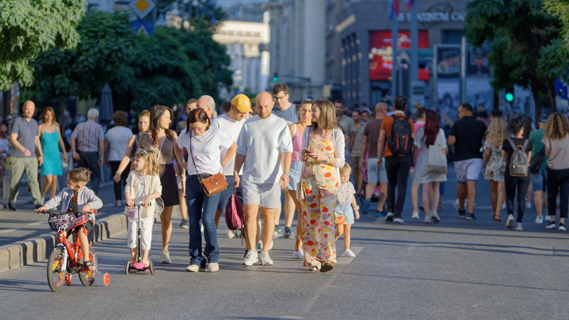 A lively crowd of pedestrians enjoying a sunny weekend